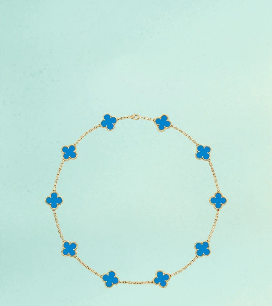 Detailed Close-Up of a Gold-Trimmed Blue Four-Leaf Clover-Shaped Pendant